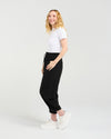 Woman wearing a white t-shirt and black pants on a white background Nova Pants Black
