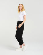 Woman wearing a white t-shirt and black pants on a white background Nova Pants Black