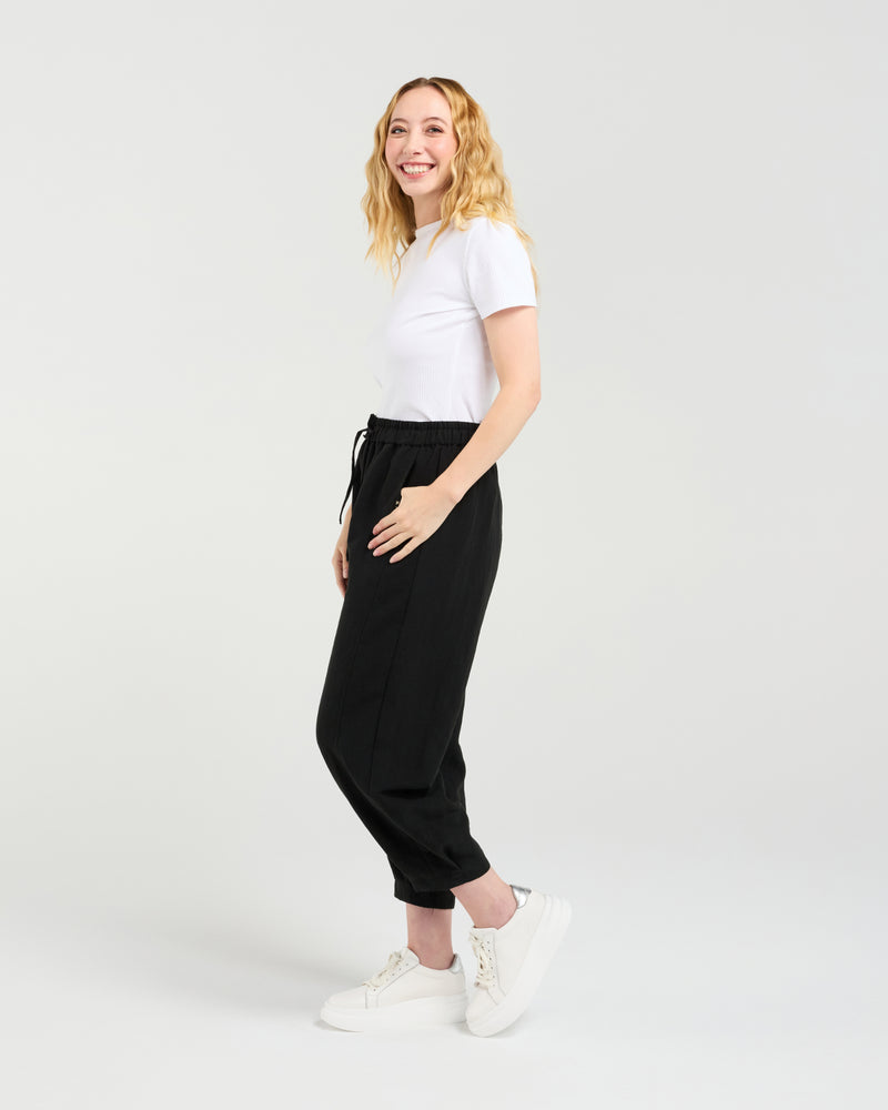 Woman wearing a white t-shirt and black pants on a white background Nova Pants Black