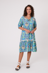 Woman wearing a colorful patterned dress on a white background Salerno Printed Dress Aqua
