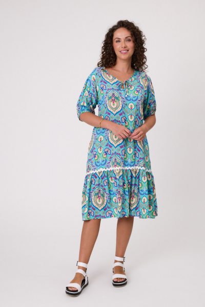 Woman wearing a colorful patterned dress on a white background Salerno Printed Dress Aqua