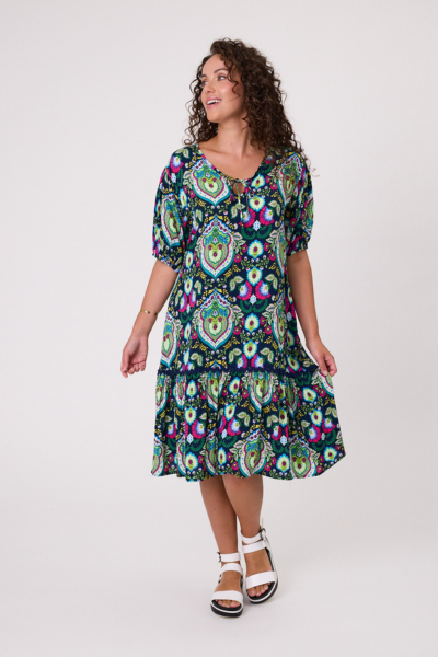 Woman wearing a colorful patterned dress on a white background Salerno Printed Dress Navy