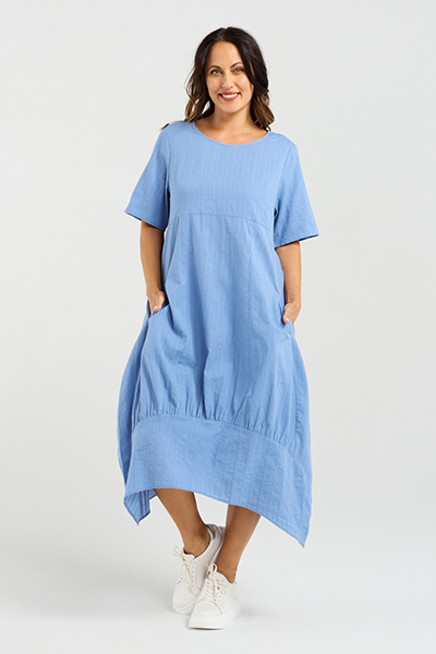 Woman wearing a blue dress on a white background Selena Dress Blue