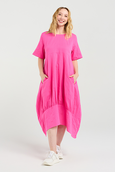 Woman wearing a bright pink dress on a white background Selena Dress Hot Pink
