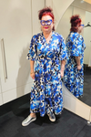 Person wearing a blue floral dress standing in front of a mirror.
Sher Dress Blue