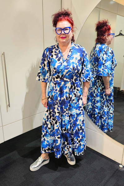 Person wearing a blue floral dress standing in front of a mirror.
Sher Dress Blue