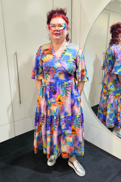 Person wearing a colorful dress standing in front of a mirror.
Sher Dress Purple