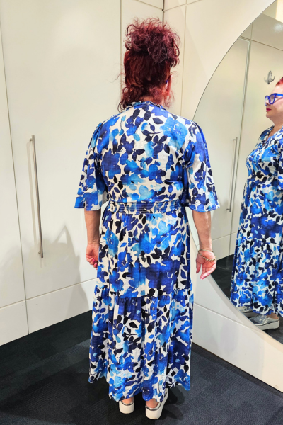 Person wearing a blue floral dress standing in front of a mirror.
Sher Dress Blue