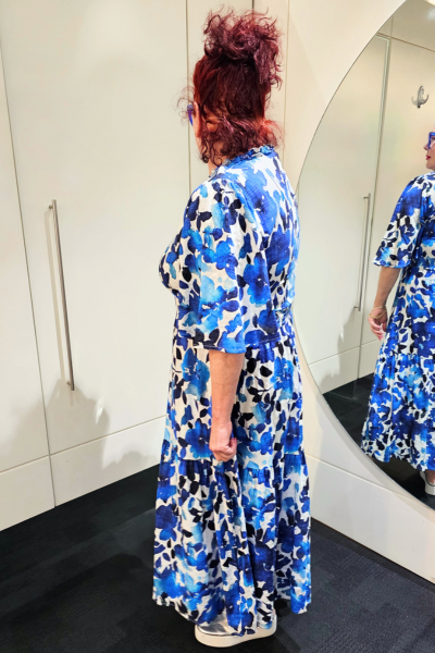 Person wearing a blue floral dress standing in front of a mirror.
Sher Dress Blue