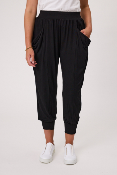 Person wearing black harem pants and white sneakers on a plain background Signature Print Fresco Pant Black