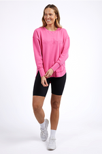 Woman wearing a pink sweatshirt and black shorts on a white background
Simplified Crew Bright Pink