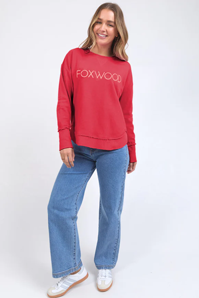 Woman wearing a red 'FOXWOOD' sweatshirt and blue jeans on a white background
Simplified Metallic Crew Red