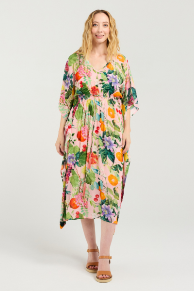 Woman wearing a colorful floral dress on a white background Sonya Dress Fruitsy