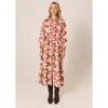 Woman wearing a floral dress on a beige background