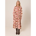 Woman wearing a floral dress on a beige background