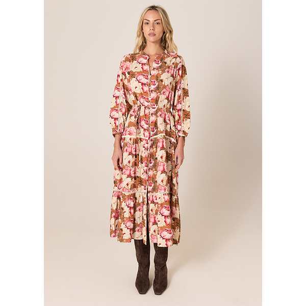Woman wearing a floral dress on a beige background