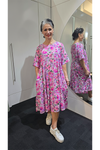 Woman wearing a pink floral dress in a mirror reflection Tiered Dress Pink