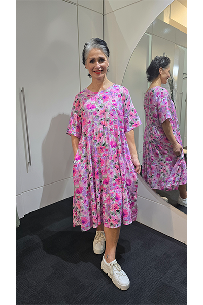Woman wearing a pink floral dress in a mirror reflection Tiered Dress Pink