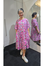 Woman wearing a pink floral dress in a mirror reflection Tiered Dress Pink