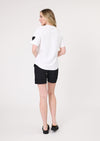Woman wearing a white t-shirt with a black heart design and black shorts on a white background
Valentina Tee White