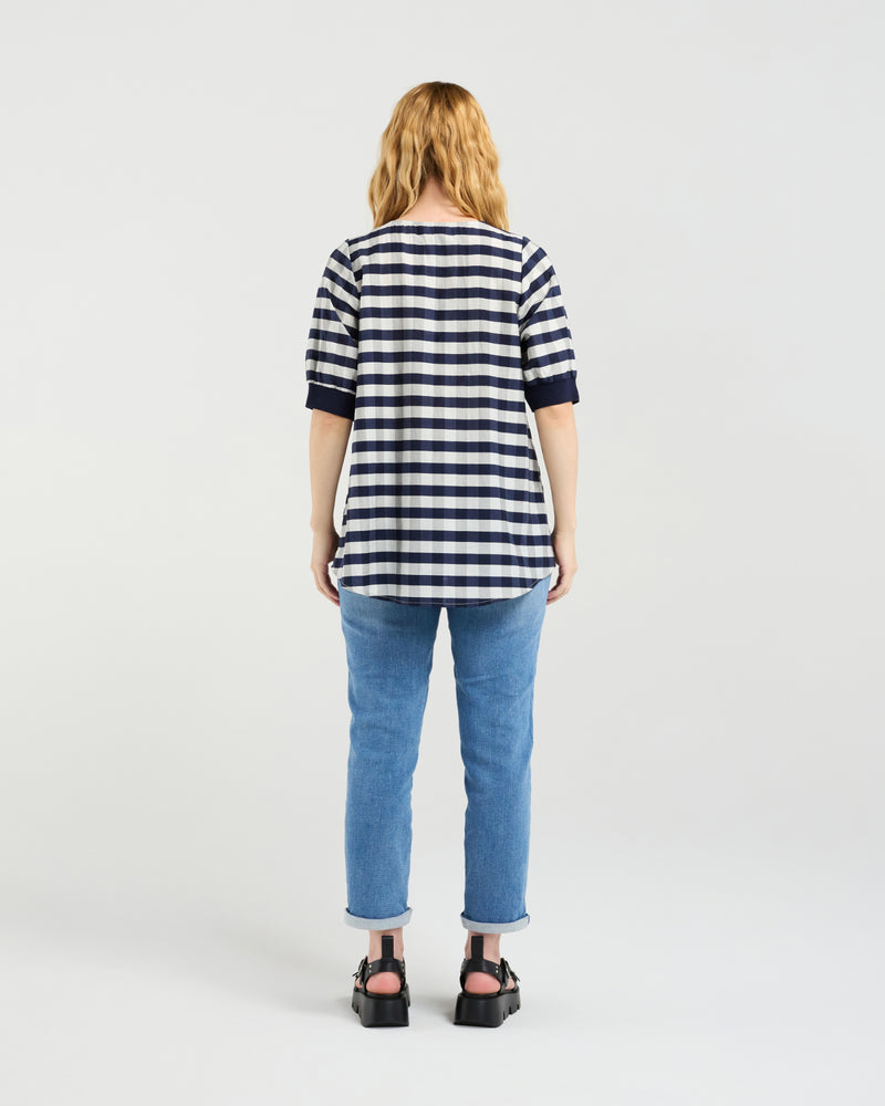 Person wearing a striped shirt and jeans from behind on a white background
Havana Top Navy Check