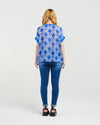 Person wearing a blue patterned top and jeans on a white background
Olivia Top Paisley Painting