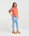 Woman wearing a colorful striped sweater and light blue jeans on a white background
Willow Top Dynamic Stripe