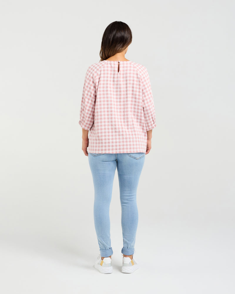 Person wearing a pink checkered shirt and light blue jeans on a white background
Hazel Top Pink Check