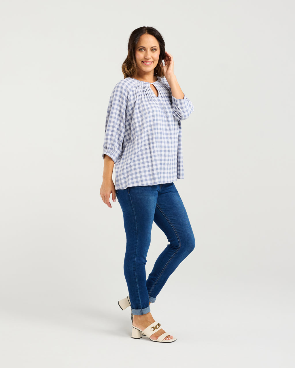 Woman wearing a blue and white checkered blouse and blue jeans on a light gray background
Hazel Top Blue Check