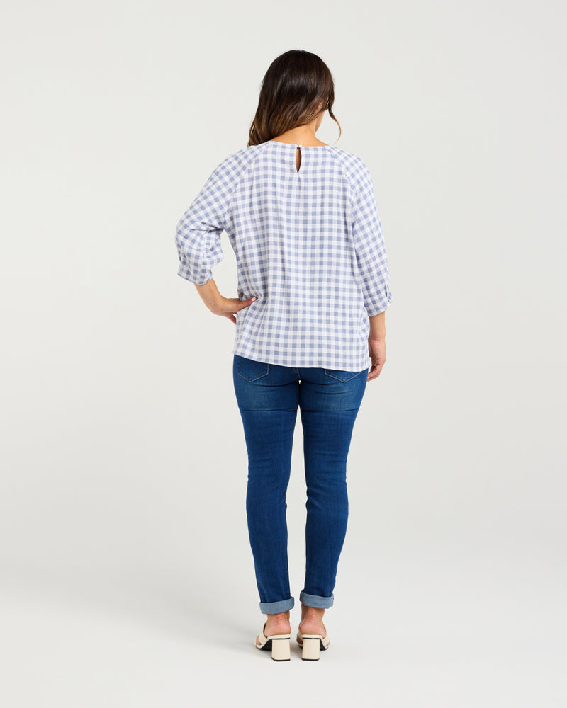 Woman wearing a blue checkered shirt and blue jeans on a white background
Hazel Top Blue Check