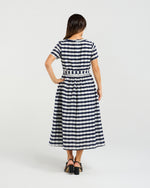 Woman wearing a navy and white striped dress on a light gray background
Scarlett Dress Navy Check