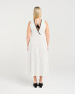 Woman wearing a white striped dress with black trim on a plain background
Zariah Dress Pinstripe