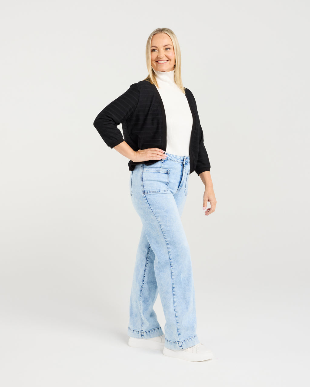 Woman wearing light blue jeans and a black cardigan on a white background
Quinn Cardi Black
