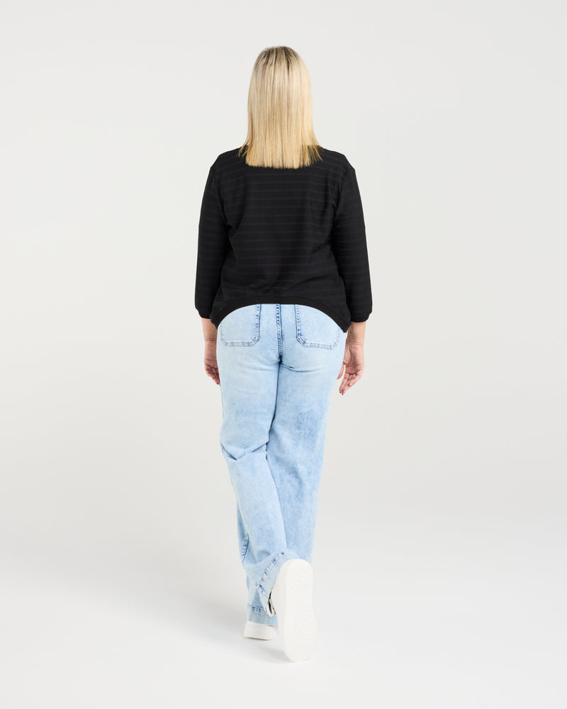 Woman wearing a black top and light blue jeans on a white background
Quinn Cardi Black
