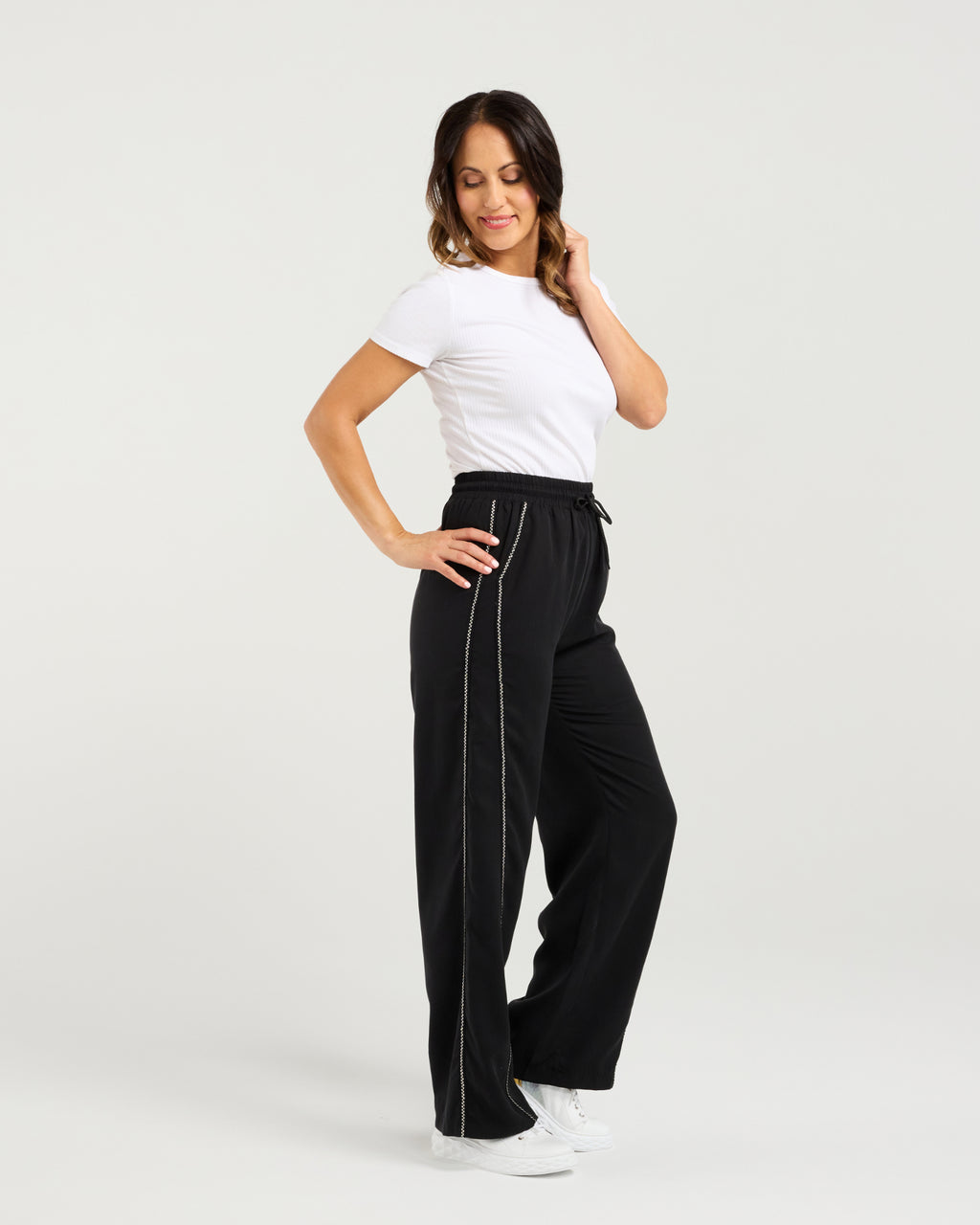 Woman wearing black high-waisted pants with white trim on a light gray background
Polly Pants Black
