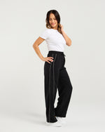 Woman wearing black high-waisted pants with white trim on a light gray background
Polly Pants Black