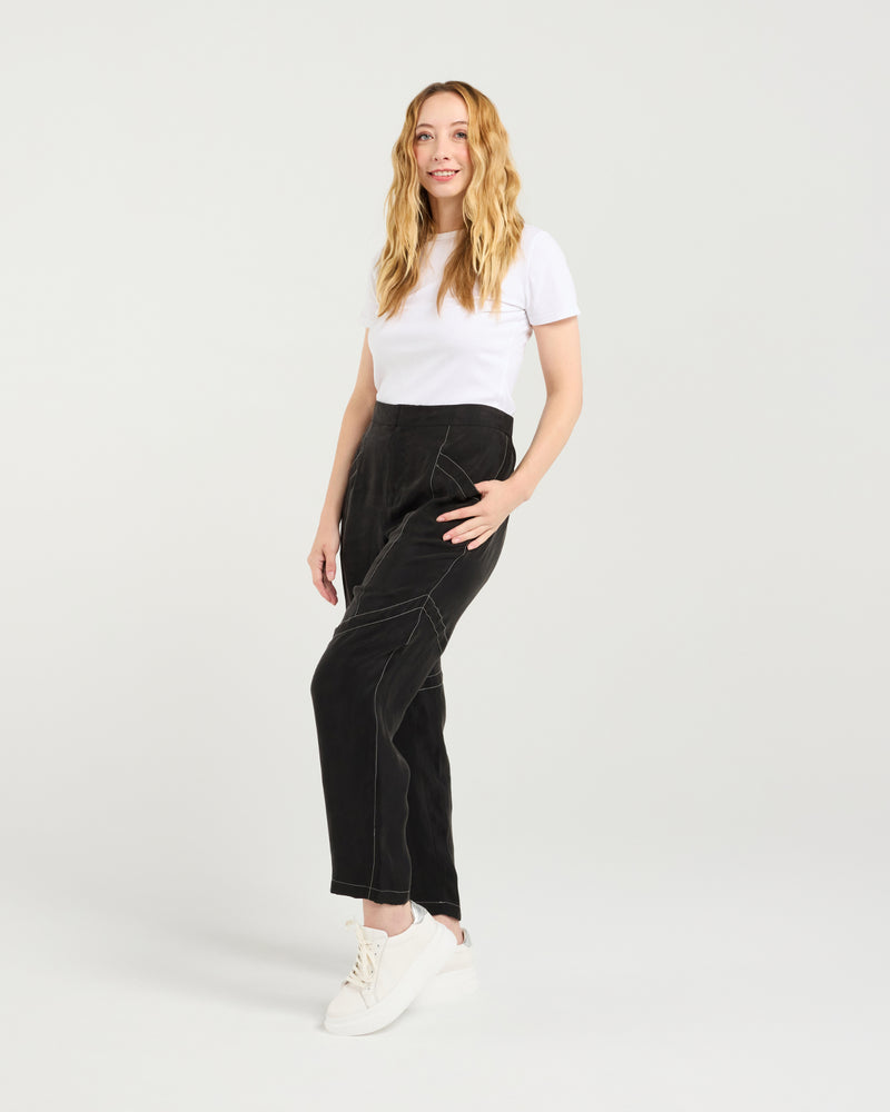 Woman wearing a white t-shirt and black pants on a plain background
Lilith Pants Black