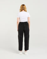 Person wearing a white t-shirt and black pants on a plain background
Lilith Pants Black