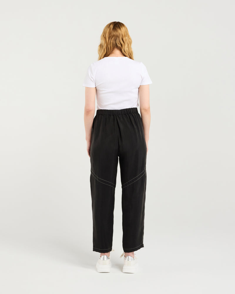 Person wearing a white t-shirt and black pants on a plain background
Lilith Pants Black