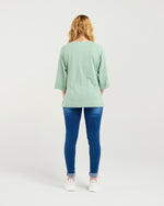Person wearing a light green top and blue jeans on a white background
Kate T-Shirt Sage