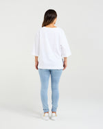 Person wearing a white shirt and light blue jeans on a plain background
Kate T-Shirt White