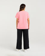 Person wearing a pink t-shirt and black pants on a white background
Livia T-Shirt Pink