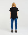 Person wearing a black t-shirt and blue jeans on a white background
Livia T-Shirt Black
