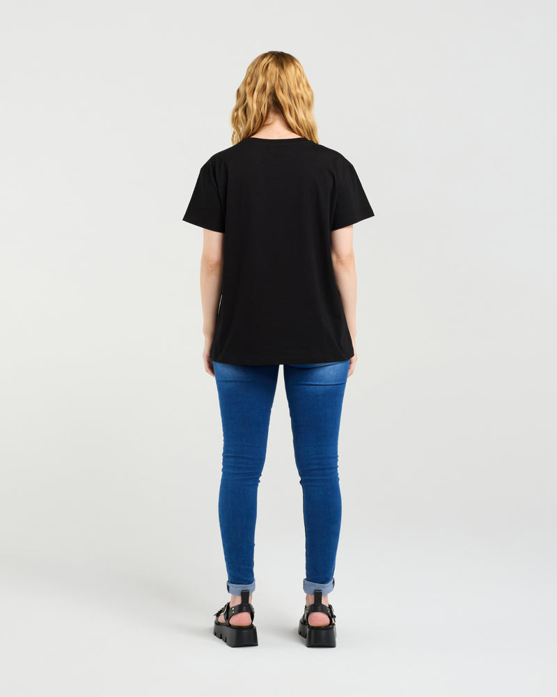 Person wearing a black t-shirt and blue jeans on a white background
Livia T-Shirt Black