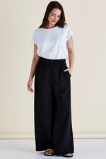 Woman wearing a white t-shirt and black wide-leg pants against a beige background
Zander Pants Black