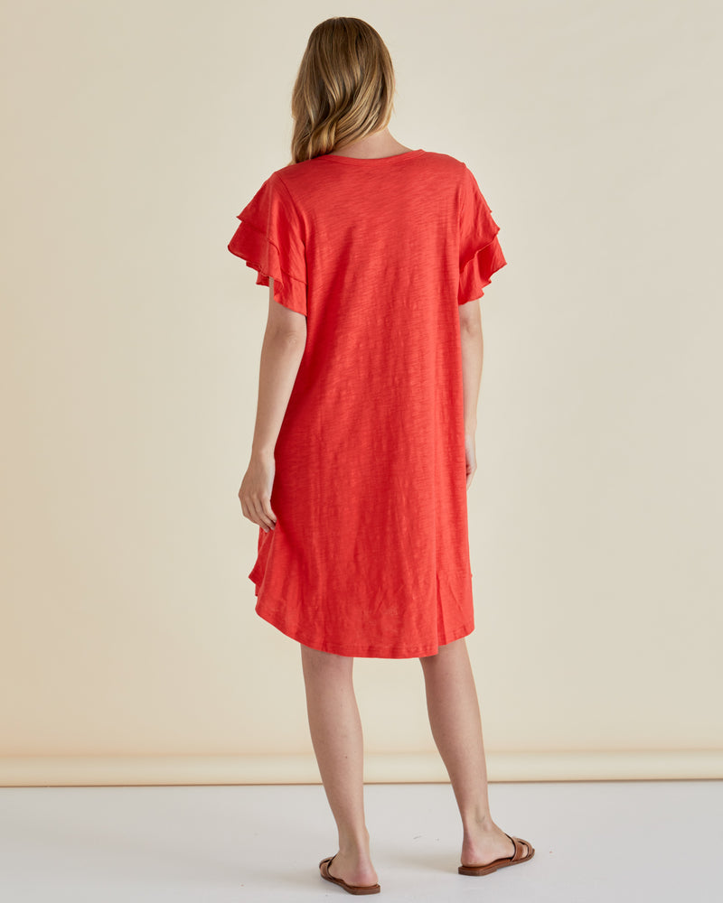 Woman wearing a red dress with ruffled sleeves against a beige background
Sydney Tee Dress Red
