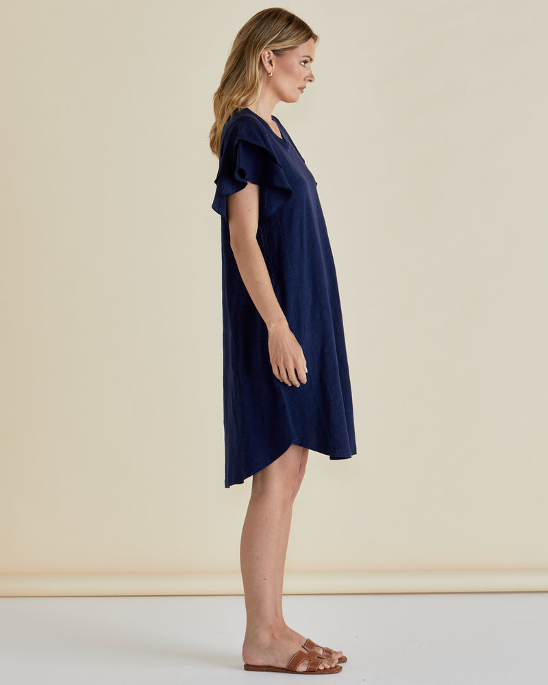 Woman wearing a navy blue dress against a beige background
Sydney Tee Dress Navy