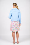 Person wearing a light blue denim jacket and a colorful floral skirt on a white background
Frayed Linen Jacket Sky Blue