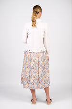 Woman wearing a white blouse and floral skirt on a white background
Frayed Linen Jacket White