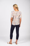 Woman wearing a floral blouse and navy pants on a white background
Printed V Neck Top Amalfi